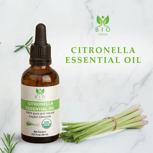 Bio Sense Citronella Essential Oil bottle with fresh citronella stalks on marble background