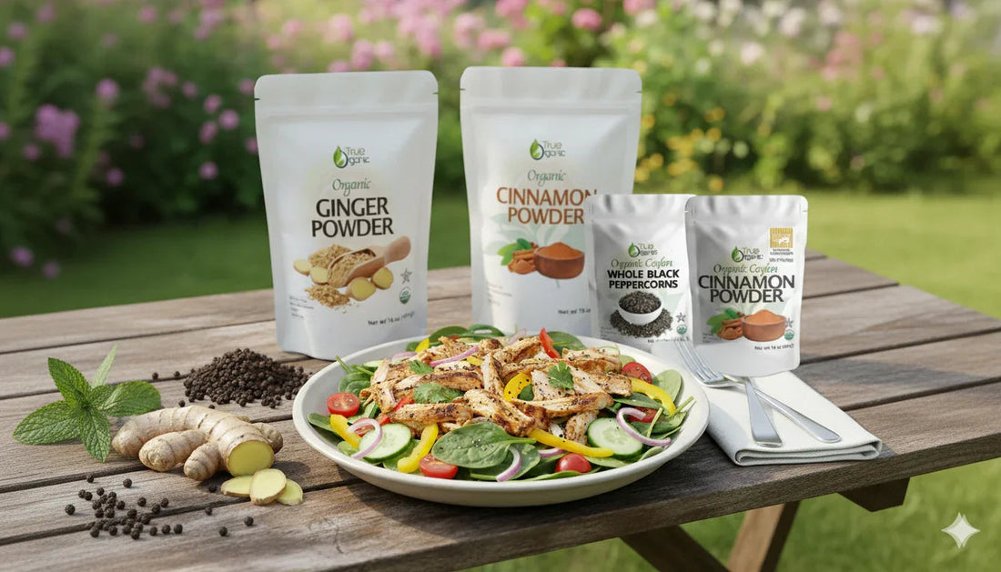 Organic ginger powder, cinnamon powder, and black peppercorns with fresh salad on wooden table outdoors