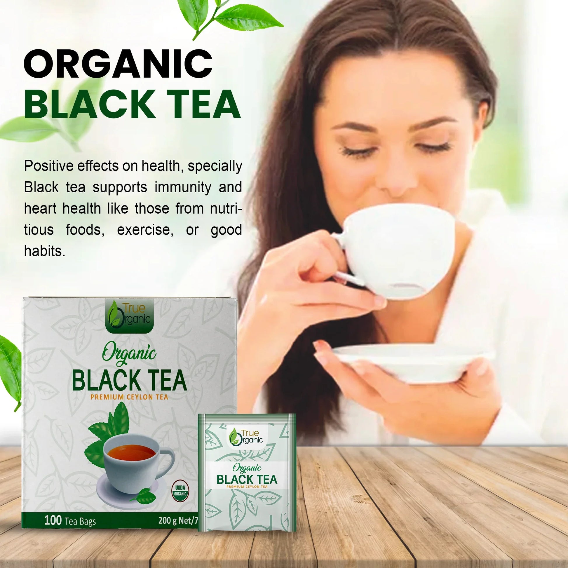 Woman enjoying organic black tea with True Organic premium Ceylon tea boxes on wooden table