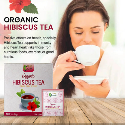 Woman drinking organic hibiscus tea with True Organic tea bag box and health benefit text