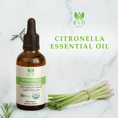 Bio Sense Citronella Essential Oil bottle with fresh citronella stalks on marble background