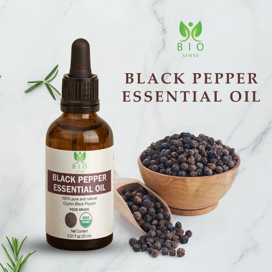 Bio Sense black pepper essential oil bottle with black peppercorns in wooden bowl and scoop