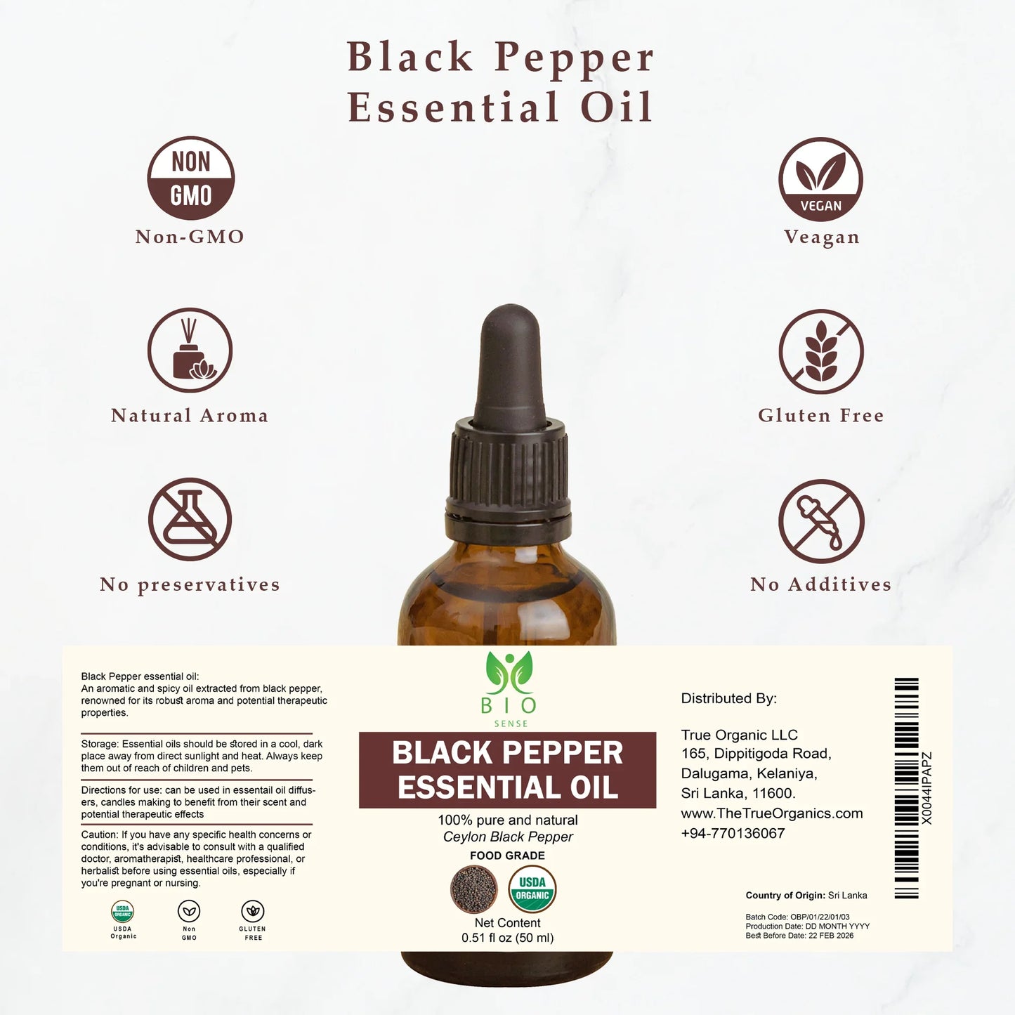 Brown glass bottle of Black Pepper Essential Oil with labels showing non-GMO, vegan, gluten-free, and natural aroma