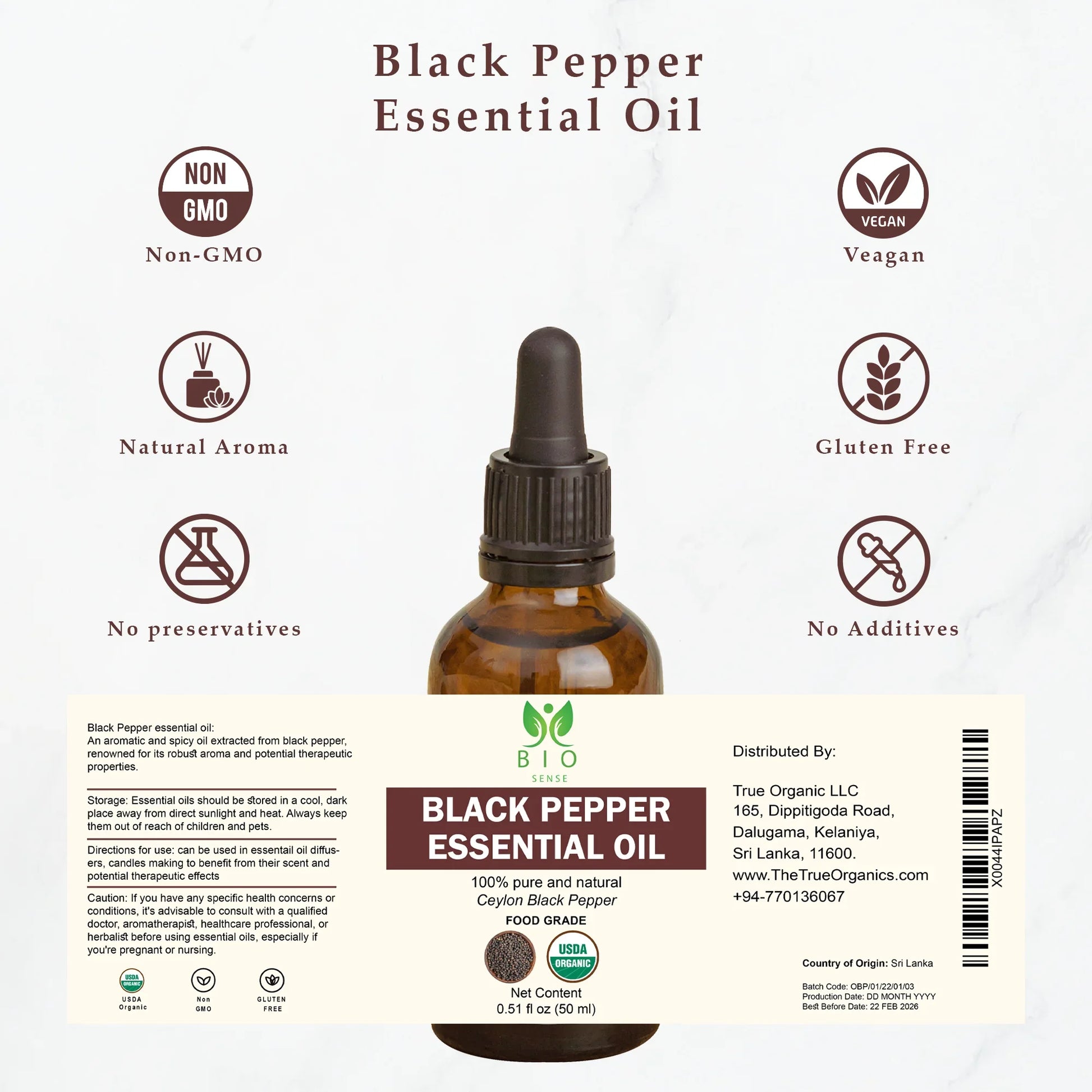 Brown glass bottle of Black Pepper Essential Oil with labels showing non-GMO, vegan, gluten-free, and natural aroma