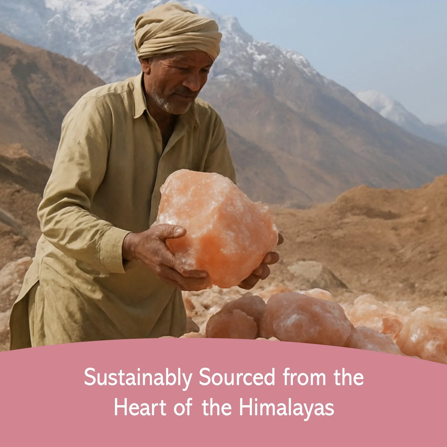 Man holding large Himalayan pink salt crystal with mountain range in background