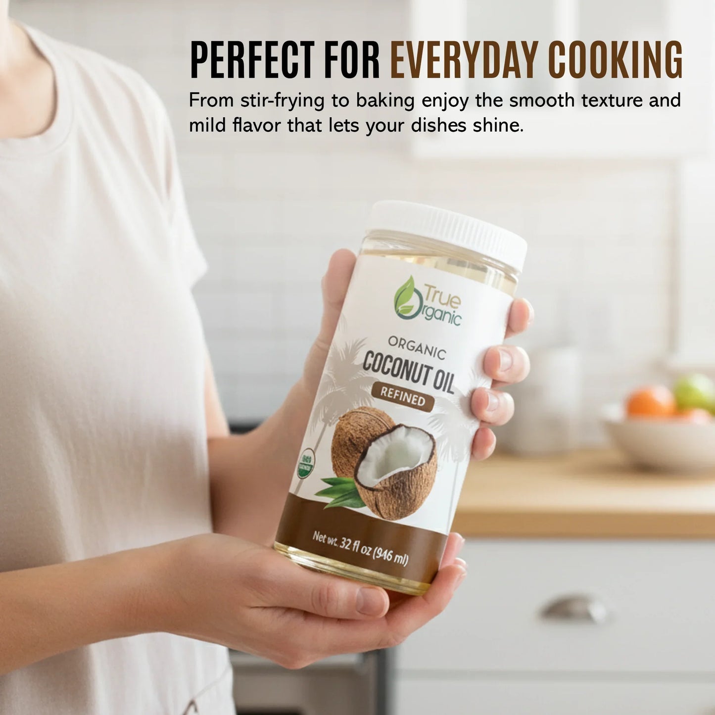 Person holding 32 fl oz bottle of True Organic refined coconut oil in kitchen